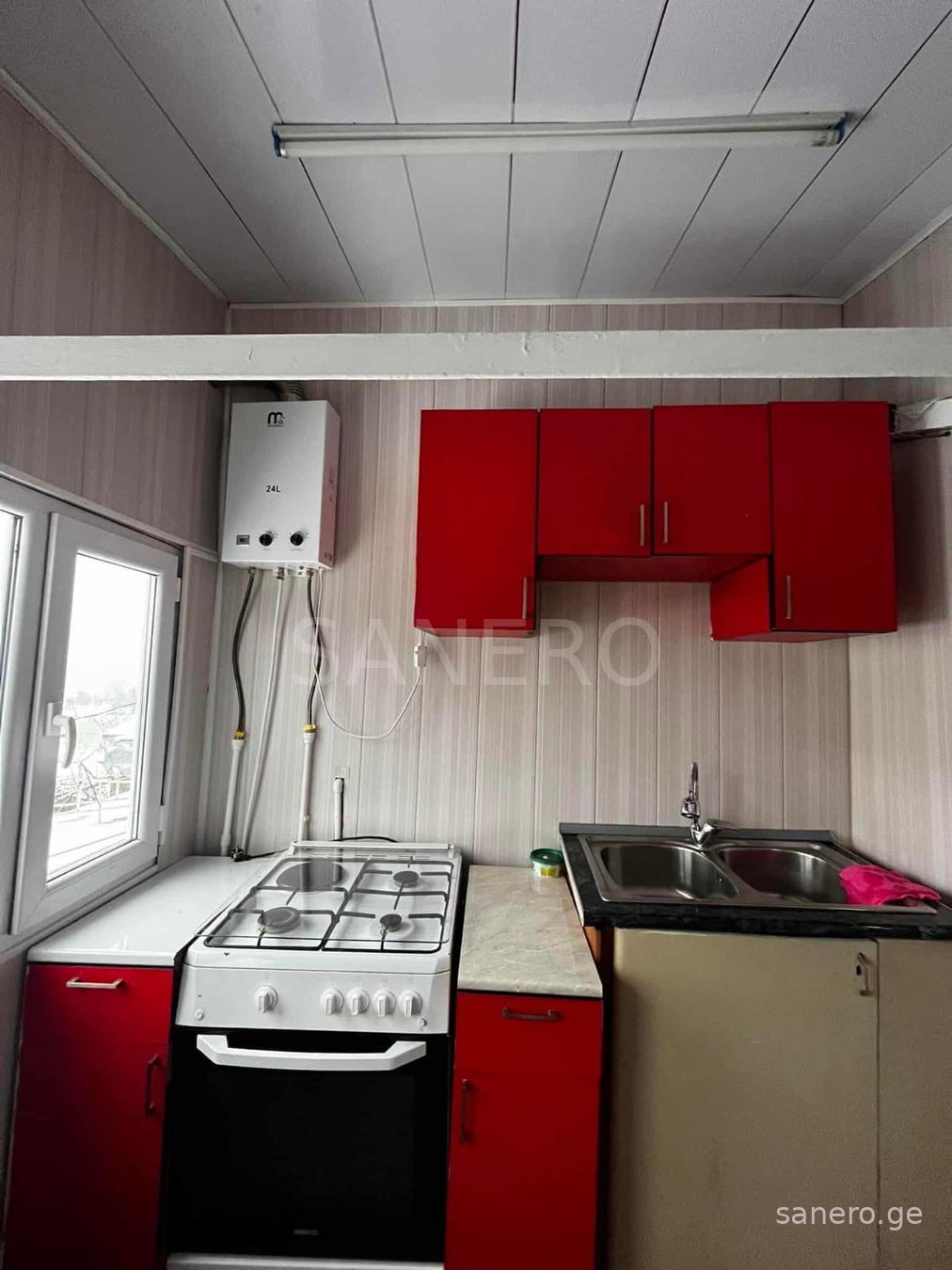 Kitchen with red cabinets and cooker