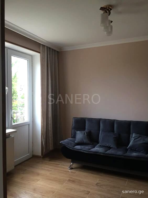 Room with sofa and balcony door