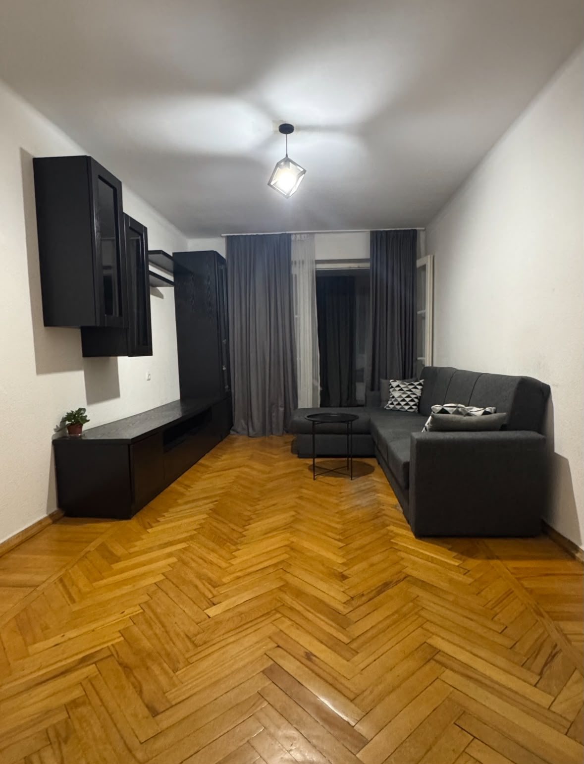 Living room with sofa and herringbone floor