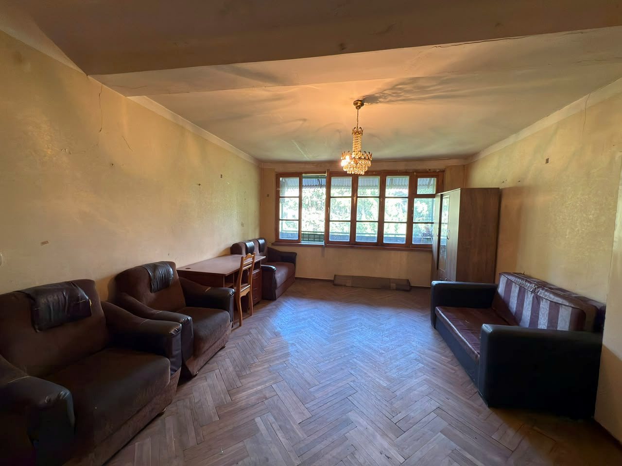 Living room with a wide window onto the balcony