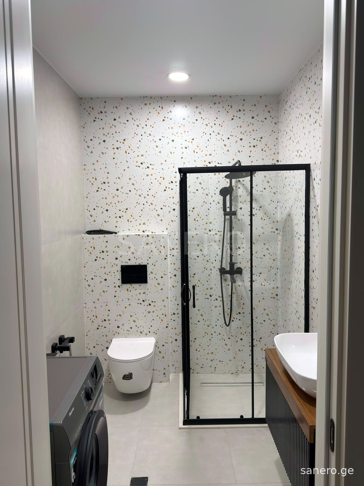 Bathroom with shower cabin and washing machine