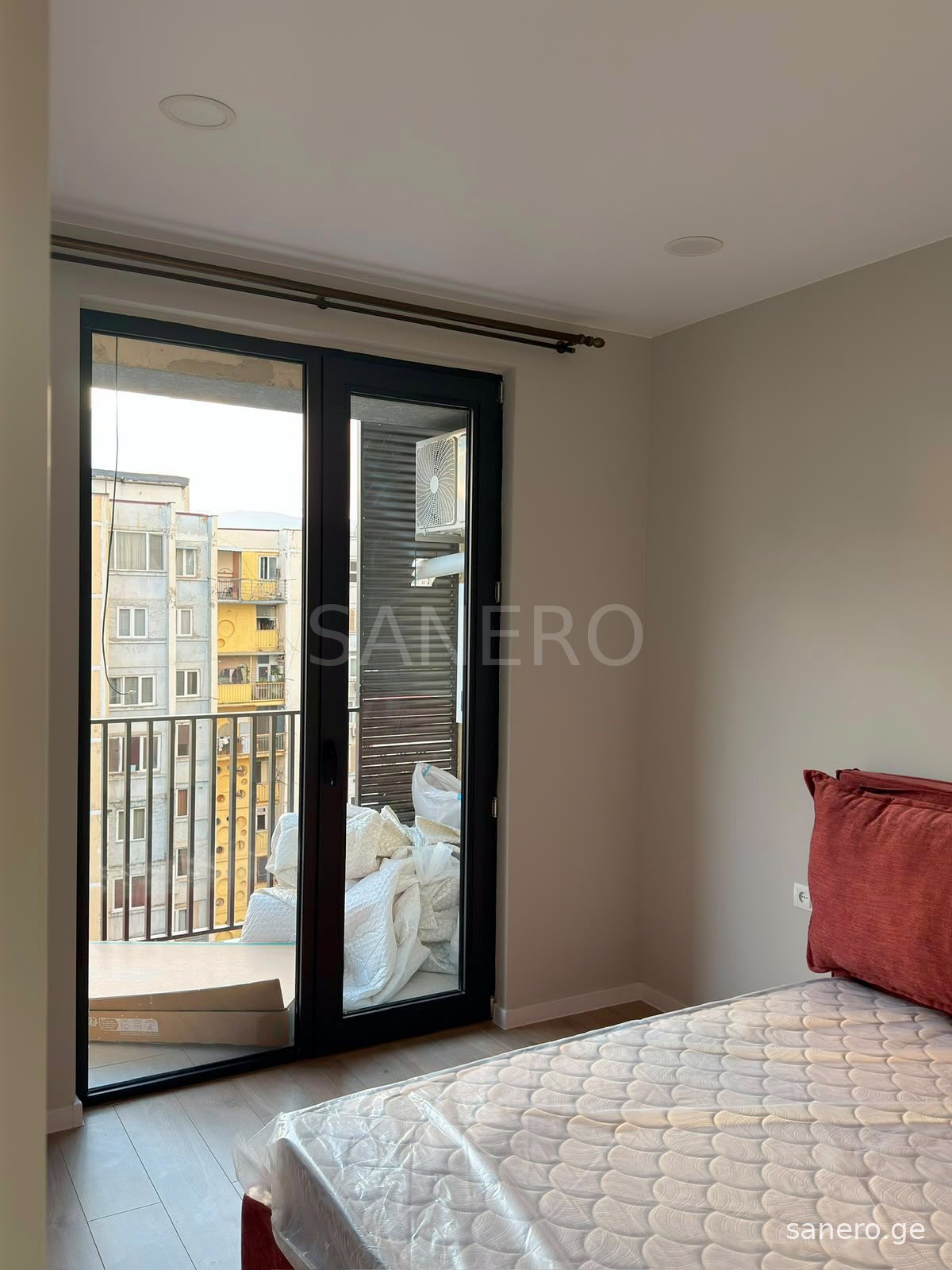 Bedroom with door to the balcony