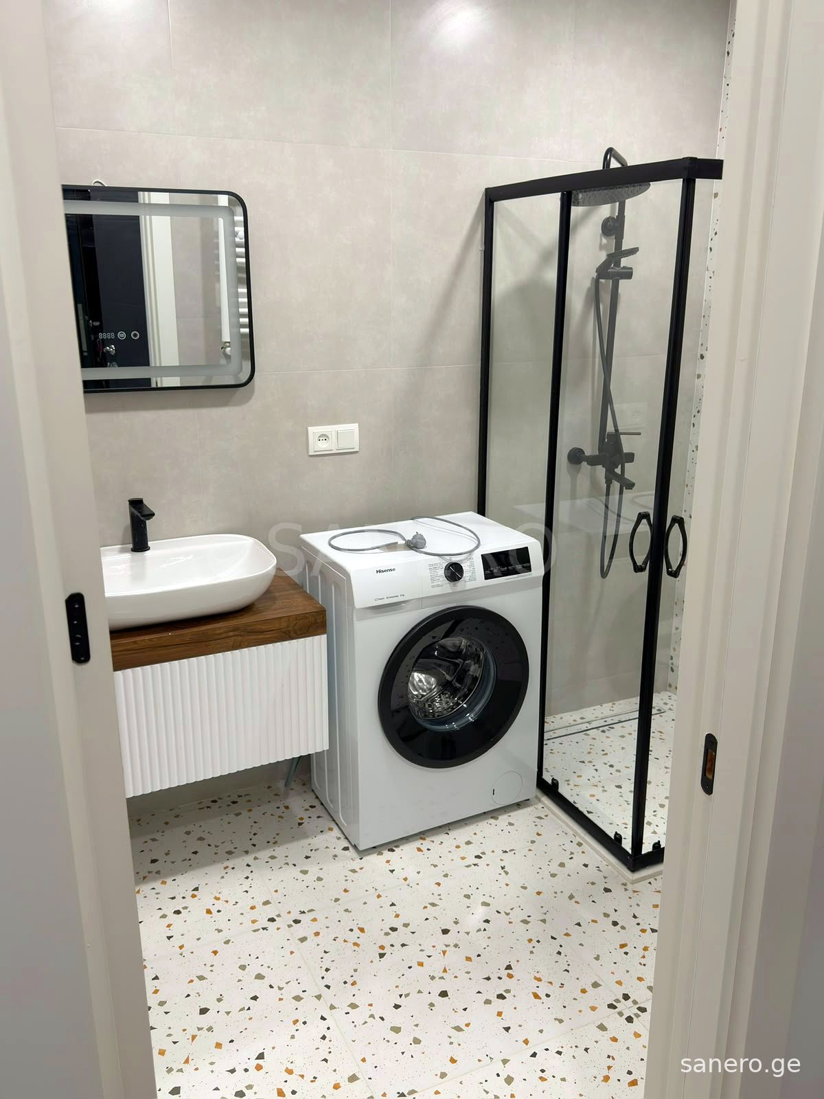 Bathroom with shower cabin and washing machine