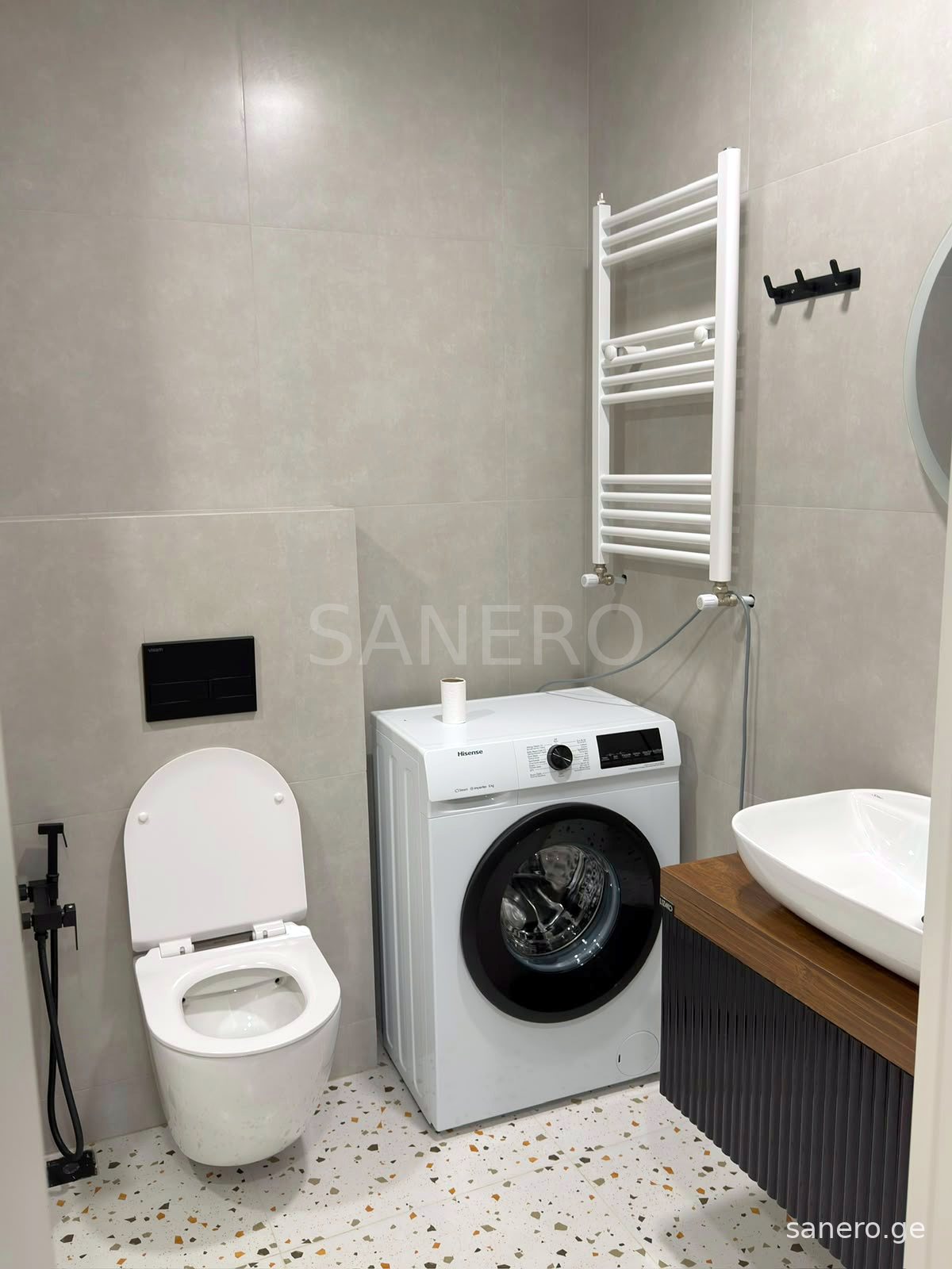 Bathroom with washing machine and towel radiator
