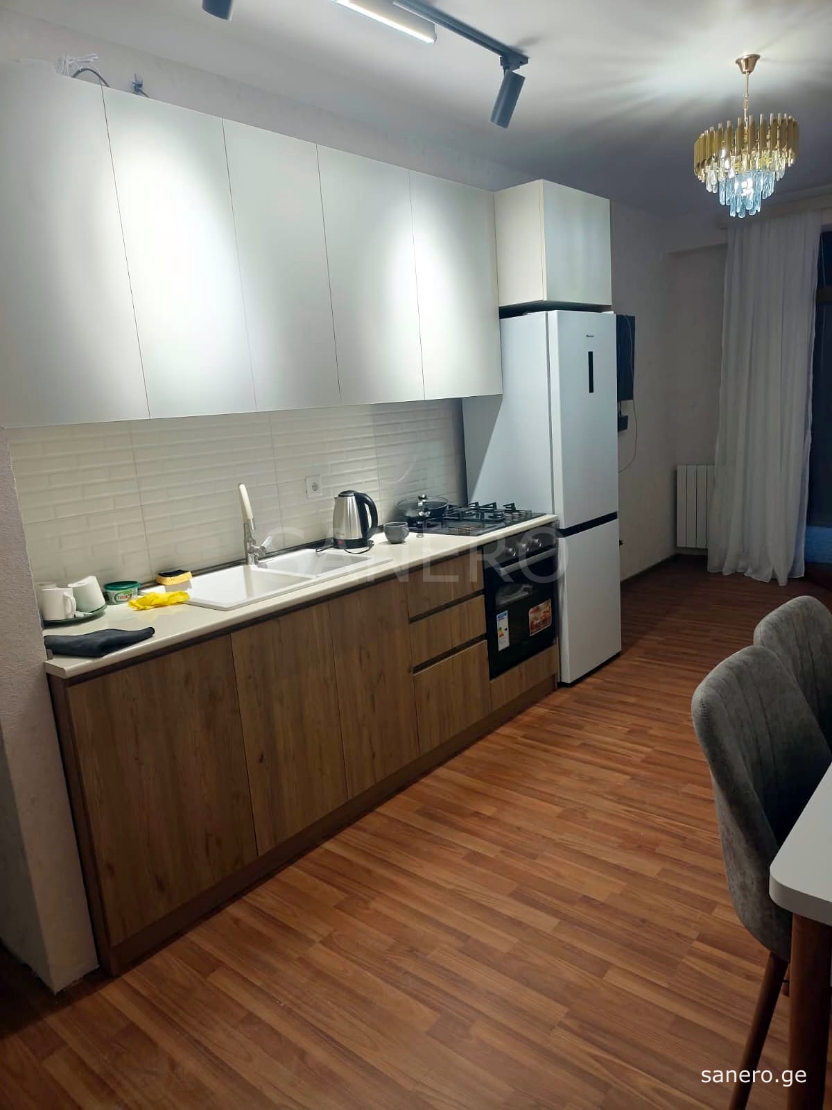 Kitchen with refrigerator, oven and gas cooktop