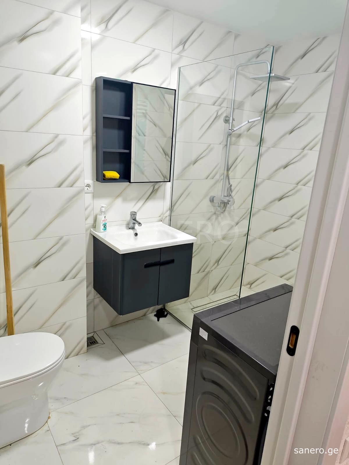 Bathroom with walk-in shower and washing machine